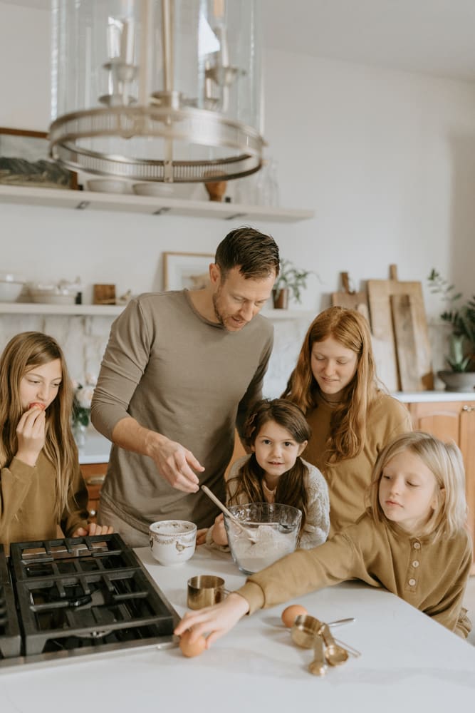 A dad and his daughters make pancakes for their Lafayette, Indiana family photography session with Vanessa Stoller.