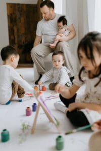 a family paints on easels for a family photo session